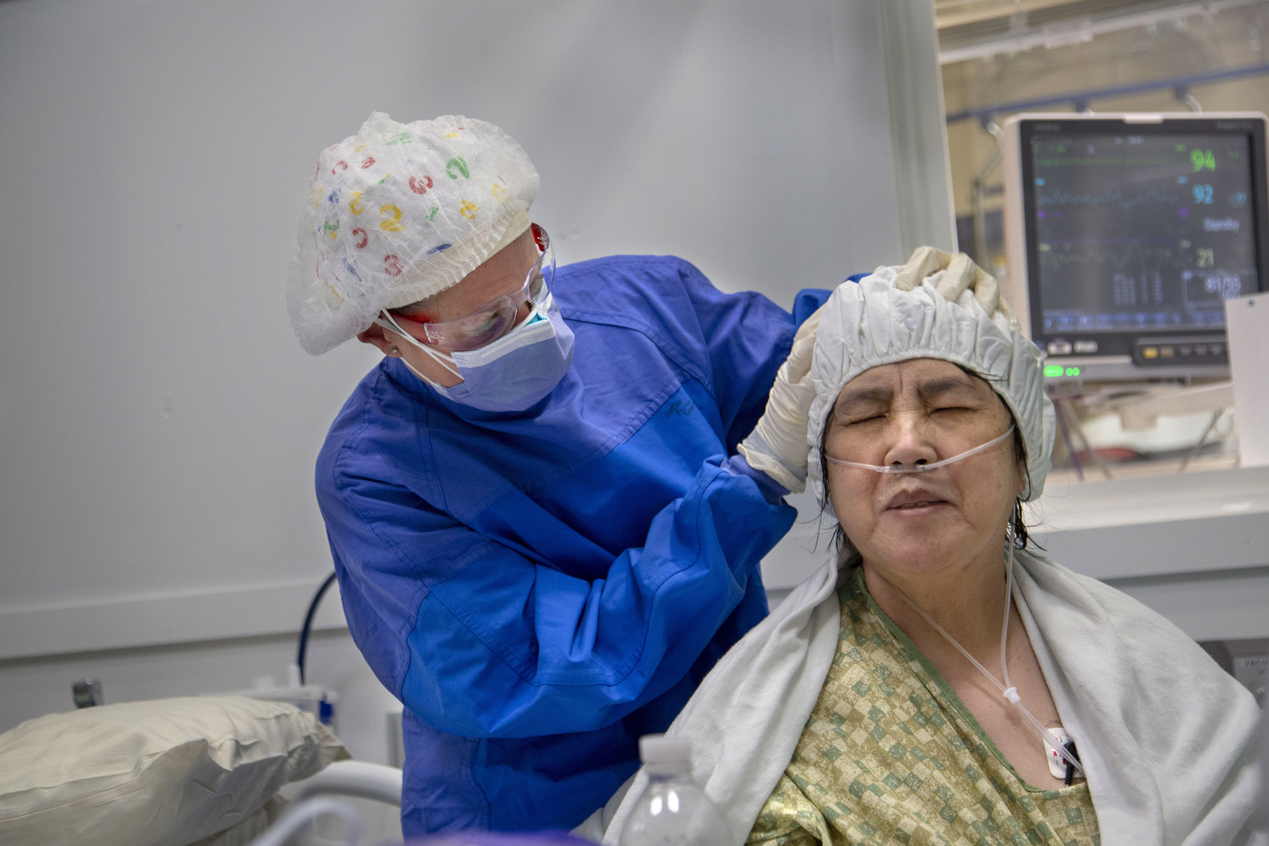 A patient gets her hair shampoo from RN Julie Falasca after being hospitalized for COVID-19 for 3 weeks at Holy Name Medical Center. 4/21/2020 Photo by Jeff Rhode