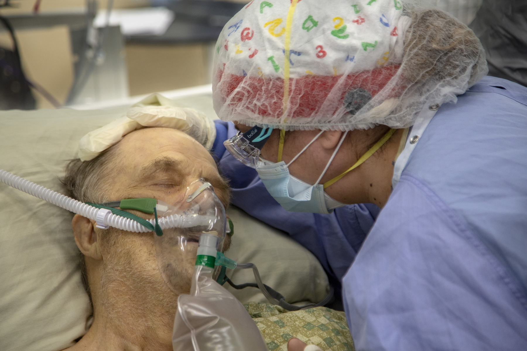 A patient is comforted in the ICU at Holy Name Medical Center. He passed hours later from COVID-19. 4/21/2020 Photo by Jeff Rhode