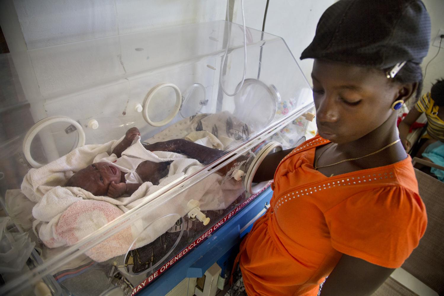 A woman comforts her child in Hospital Sacre Coeur in Milot, Haiti.