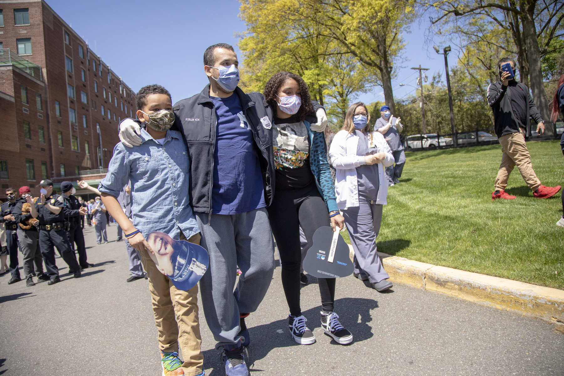 A patient leaving the hospital for COVID-19 is escorted by his family and staff at Holy Name Medical Center during a clap out. 5/12/2020 Photo by Jeff Rhode